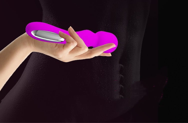 A tantalizing image capturing a feminine hand presenting a vibrant pink vibrator, its sleek and sensuous design cradled delicately against a shadowed silhouette. This provocative scene evokes a whisper of mystery and the promise of unforgettable nights filled with intense, spine-tingling pleasure.