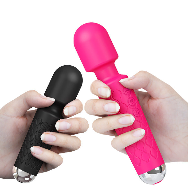 Two hands provocatively grip a pair of sleek vibrators, one in seductive black and the other in hot pink, ready to unleash powerful pleasures. These naughty toys, adorned with textured patterns for extra stimulation, beckon with their promise of intense, shiver-inducing vibrations and wild nights of fun