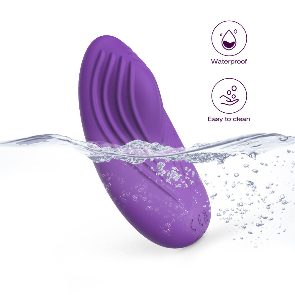Dive into the depths of pleasure with this seductive purple vibrator, elegantly submerged in water, highlighting its waterproof and easy-to-clean features. The ripples and droplets on its silky silicone surface promise a tantalizingly smooth experience, perfect for adventurous play in any wet or wild setting.