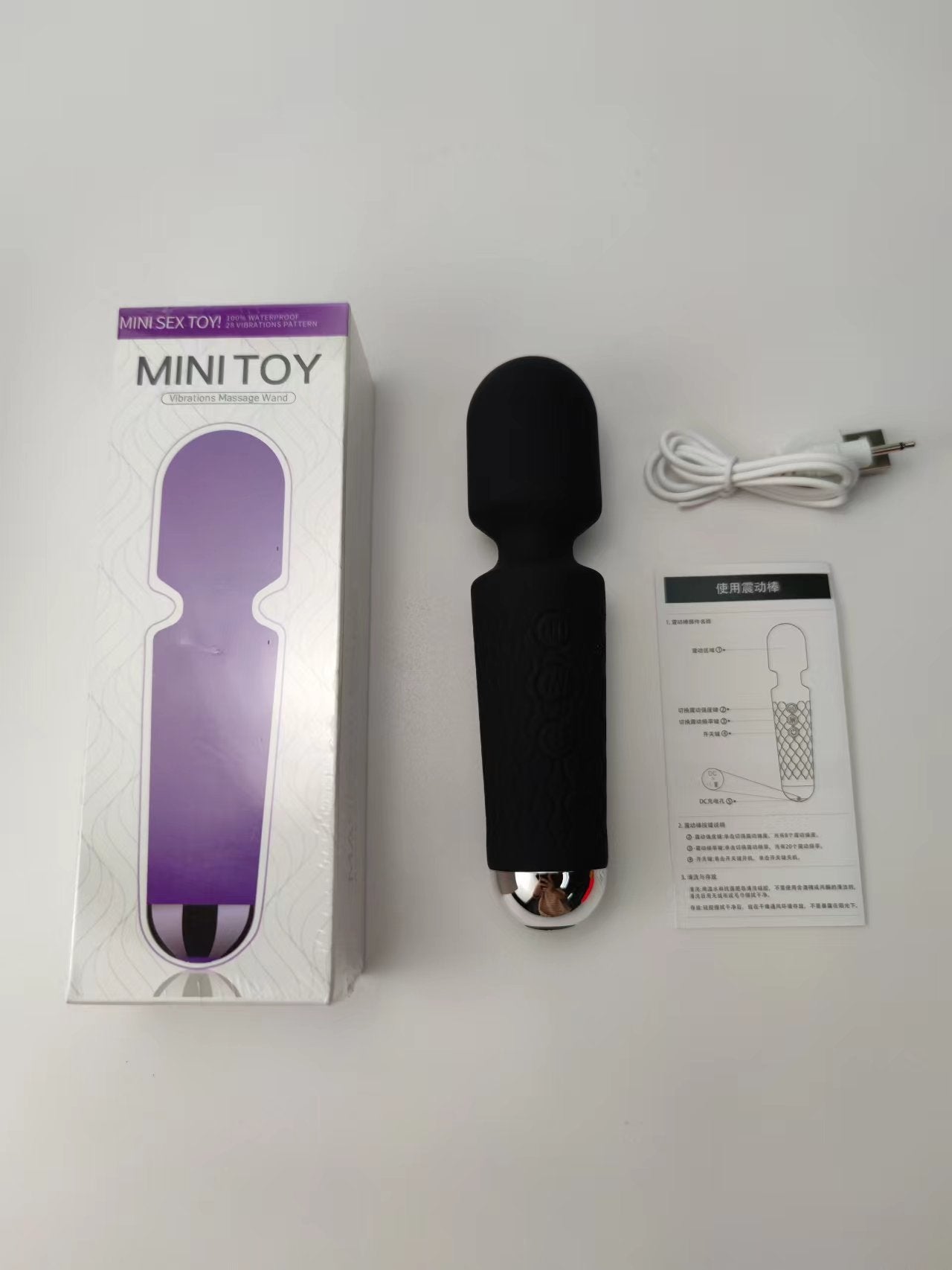 Unveil the thrill with this dark and mysterious black vibrator, displayed alongside its packaging and a USB charging cable. The box promises 100% waterproof pleasure, ensuring that this enticing toy is ready for some steamy adventures. The design is detailed with a textured grip for enhanced handling, making every touch intensely satisfying.